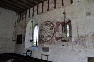 The north wall with its paintings of the Wheel of Life, and those of St Anthony of Egypt and St Michael and the Virgin, either side of window.