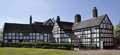 To the left is the dairy, with the Tudor and 17th century hunting lodge in the centre. The Victorian wing is on the right, painted in black and white to represent a half-timbered Tudor construction.